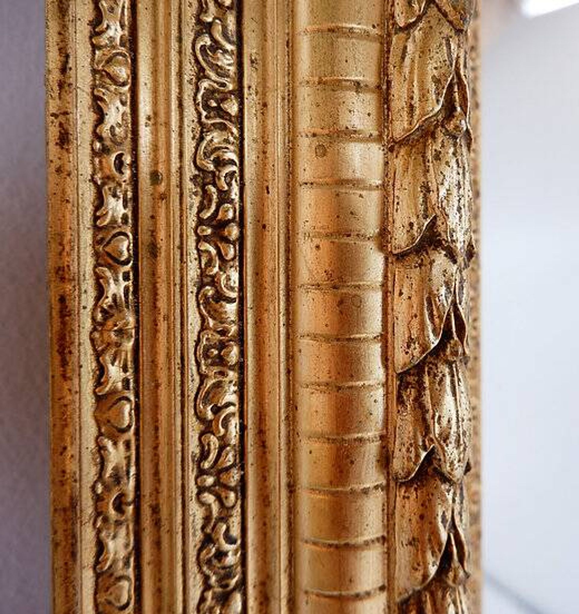 Large gilded wood and stucco mirror with foliage