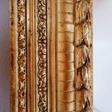 Large gilded wood and stucco mirror with foliage