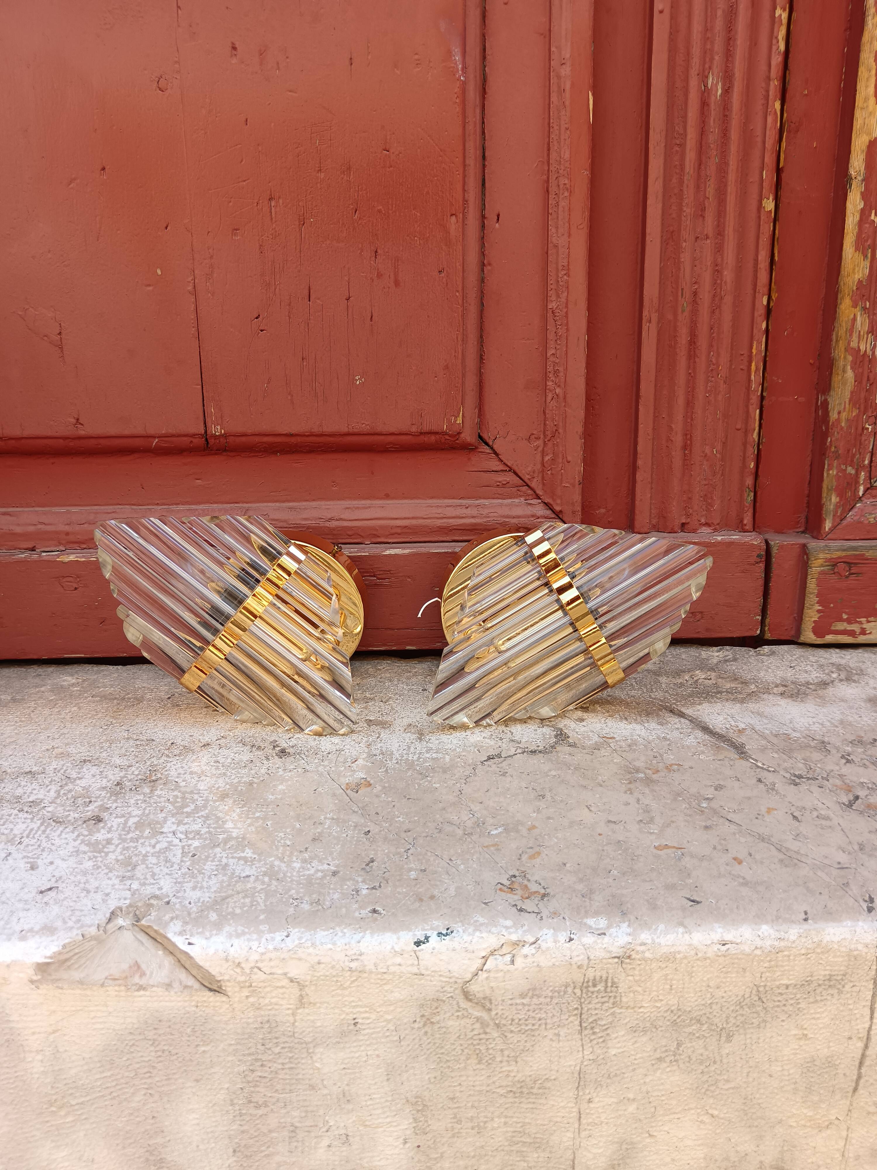 Pair of wall sconces in crystal glass and gilded brass. Venini style.