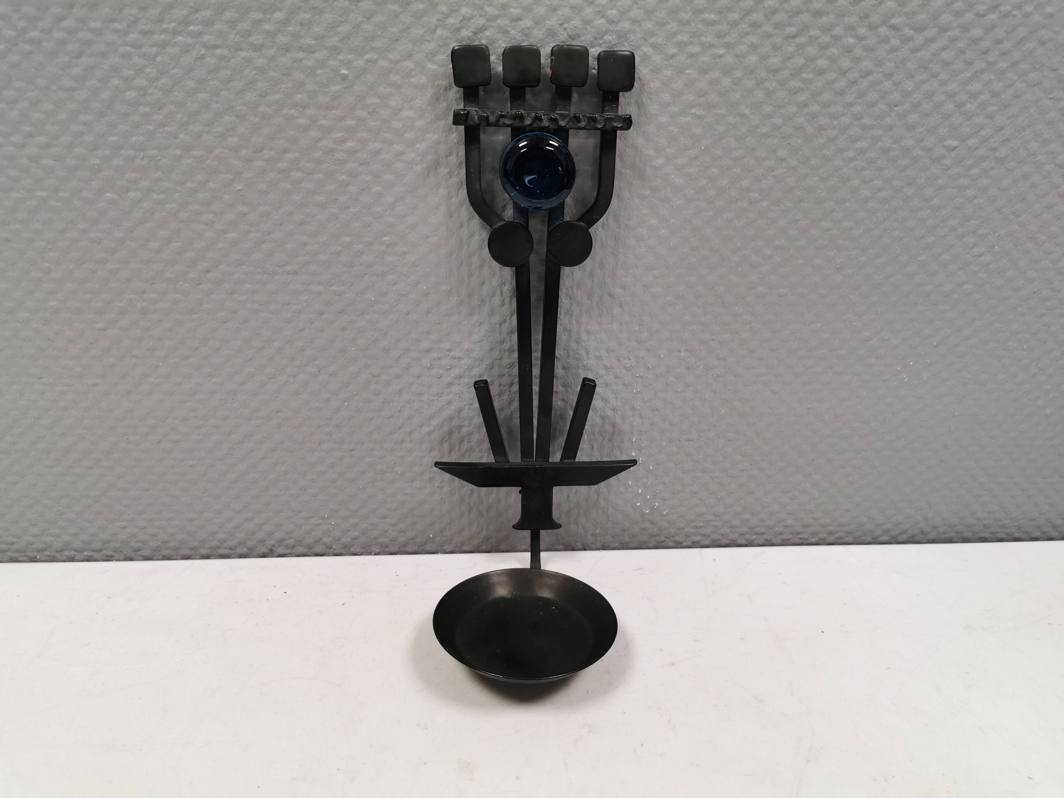 Vintage wall candle holder in wrought iron and hard pressed blue glass.