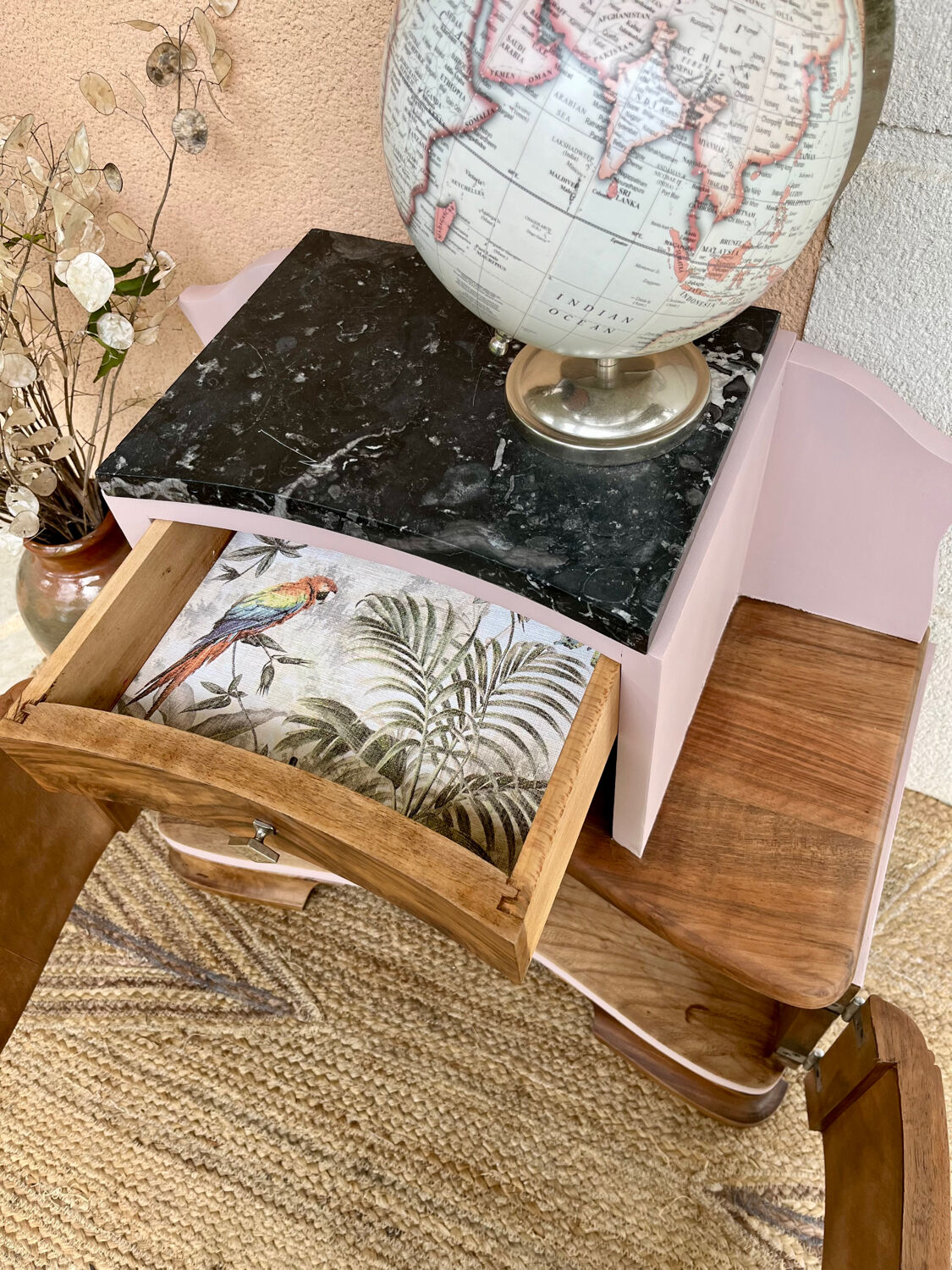 Art Deco bedside table in powder pink painted wood.