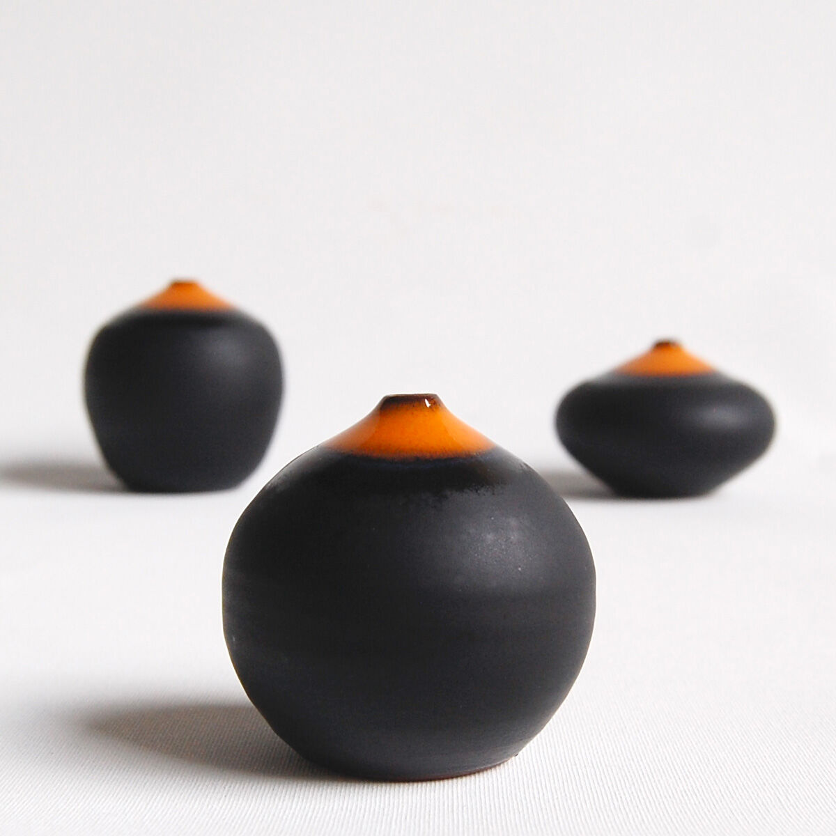 Trio of miniature black and orange ceramics Antonio Lampecco