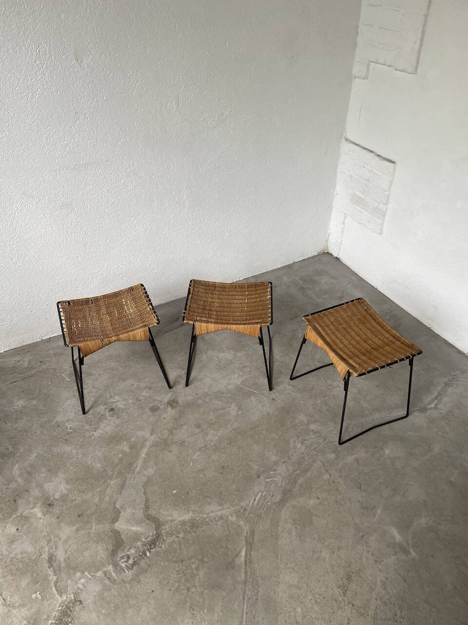 Set of three Raoul Guys wicker and metal stools