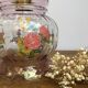 Vintage pink glass hand lamp with flower motifs