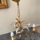 Golden metal chandelier decorated with flowers
