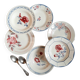 Mismatched old soup plates accompanied by a soup tureen