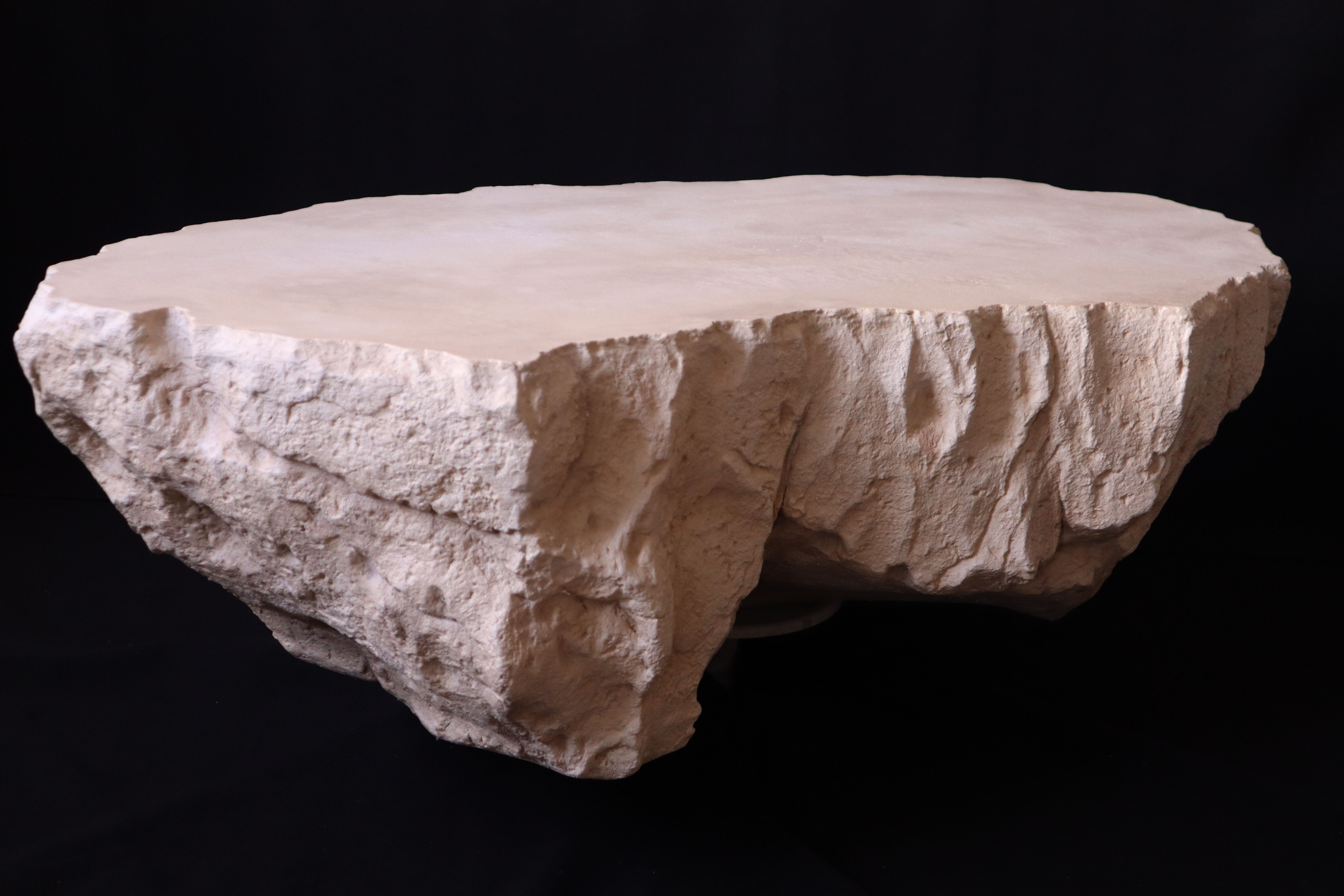 Designer coffee table with travertine rock effect — unique handcrafted piece.