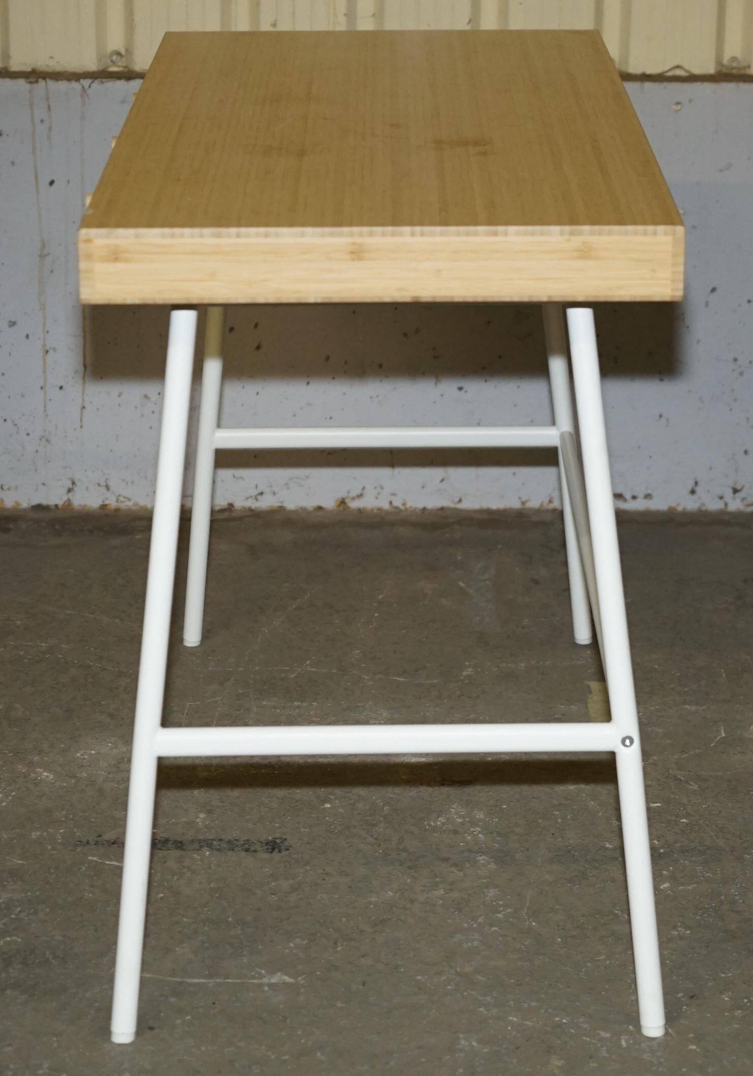 Small bamboo desk with three drawers.