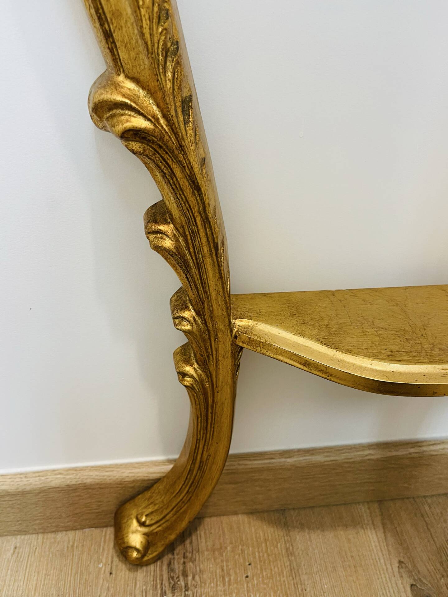 Golden console in Louis XV Rococo style made of resin.