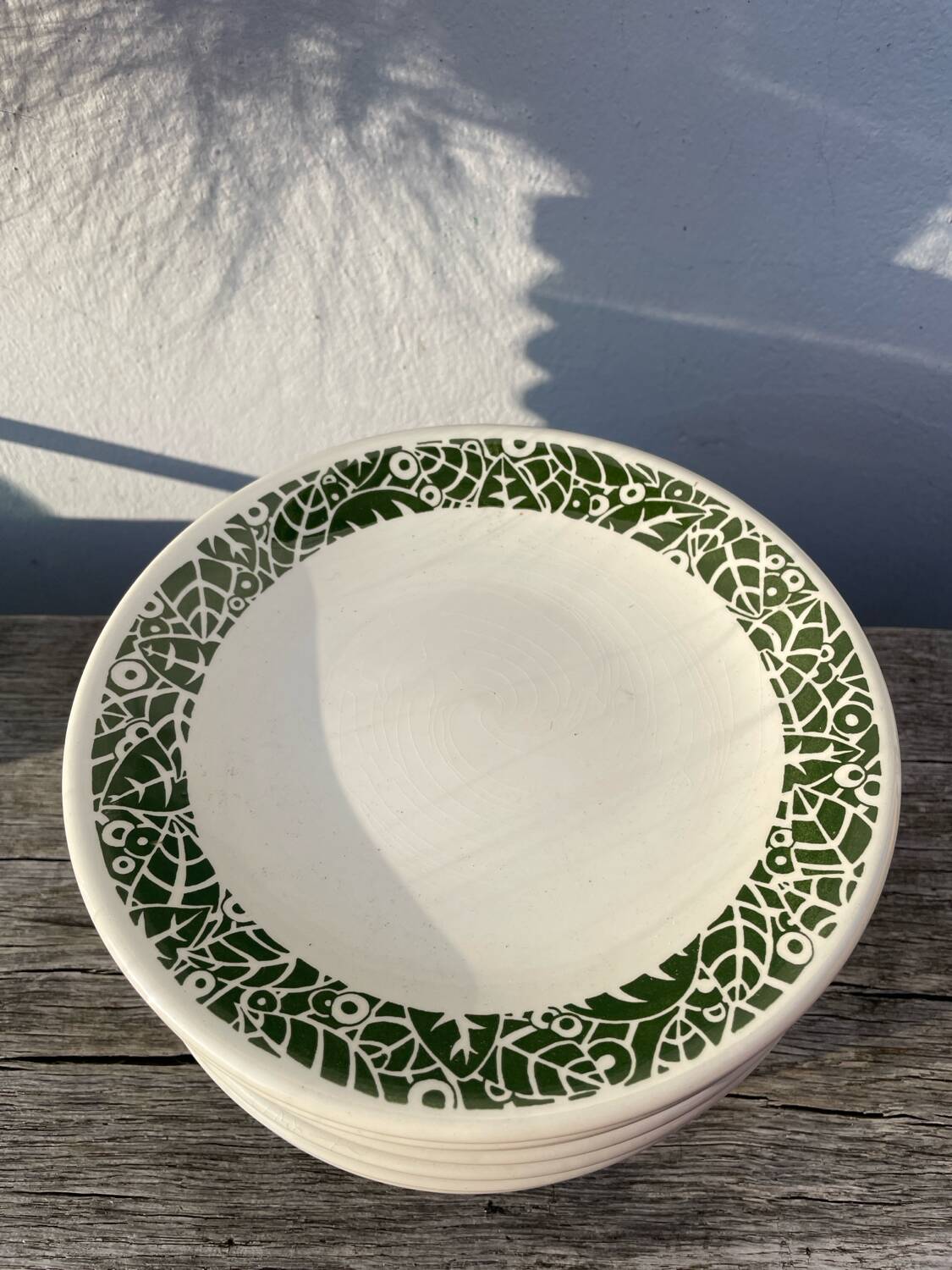 11 vintage Sado International dinner plates with plant motifs