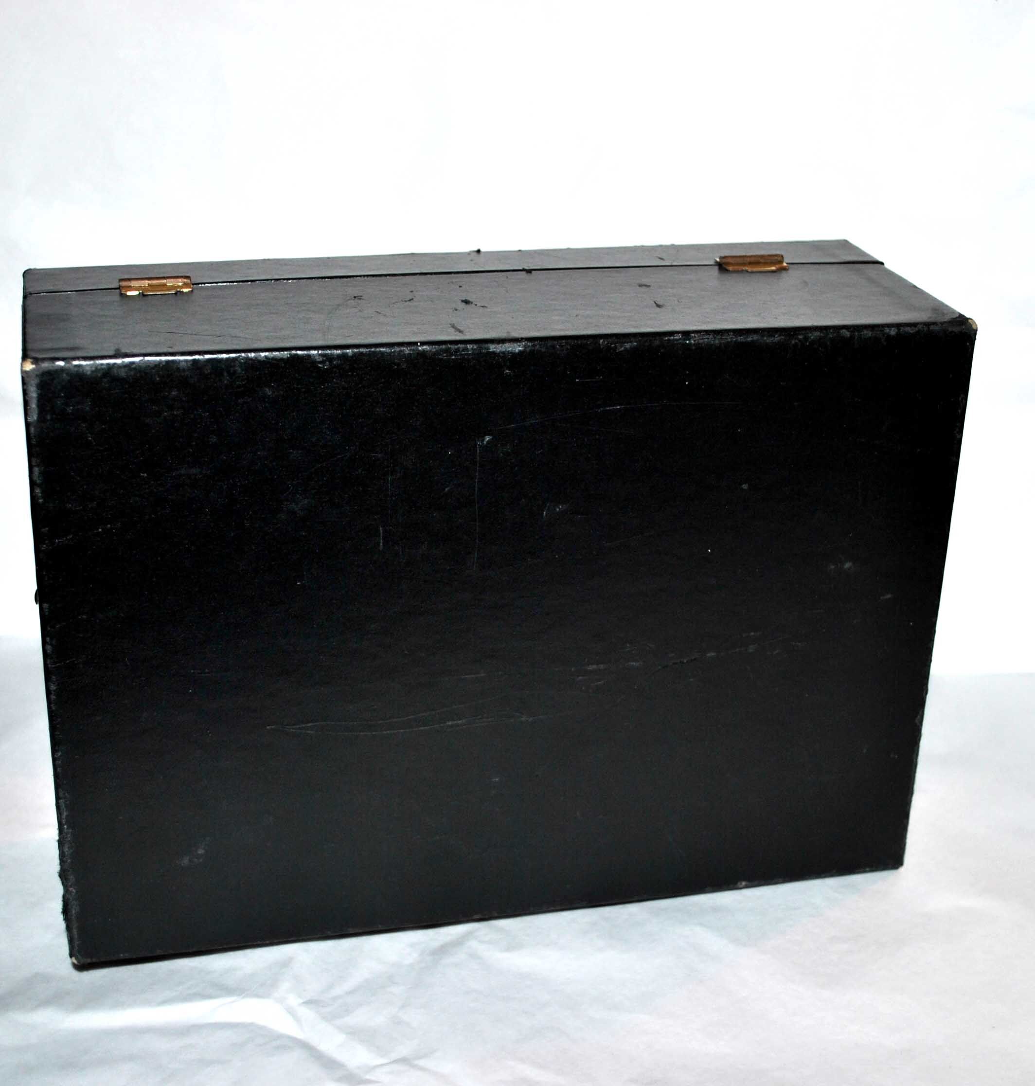 Vintage jewelry box in black leather and red interior