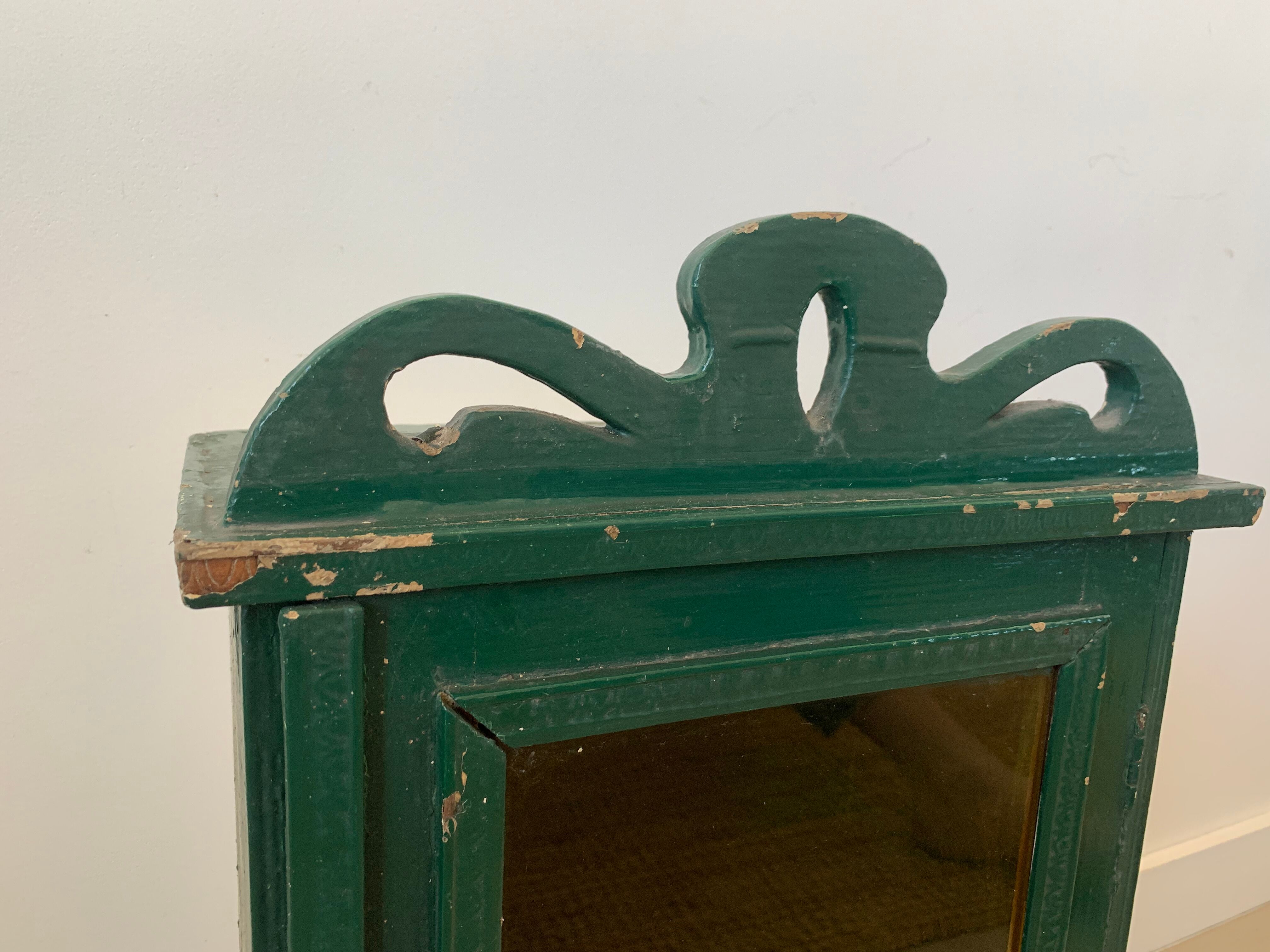 Wall vitrin with pediment