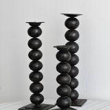 three designer candle holders in matte black metal