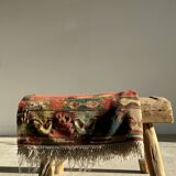 Small wool rug, predominantly red with geometric patterns