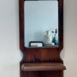 Wooden wall mirror with its shelf