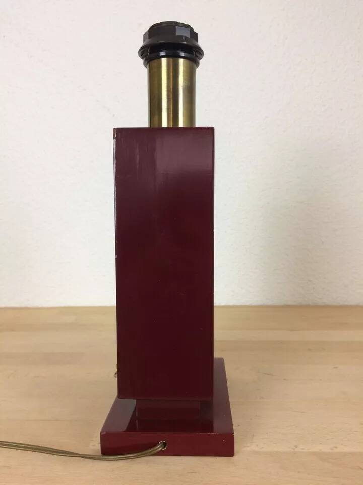 1980s vintage lamp base in red wood and gold metal.