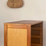 Vintage 1960s chest of drawers with covered handles.