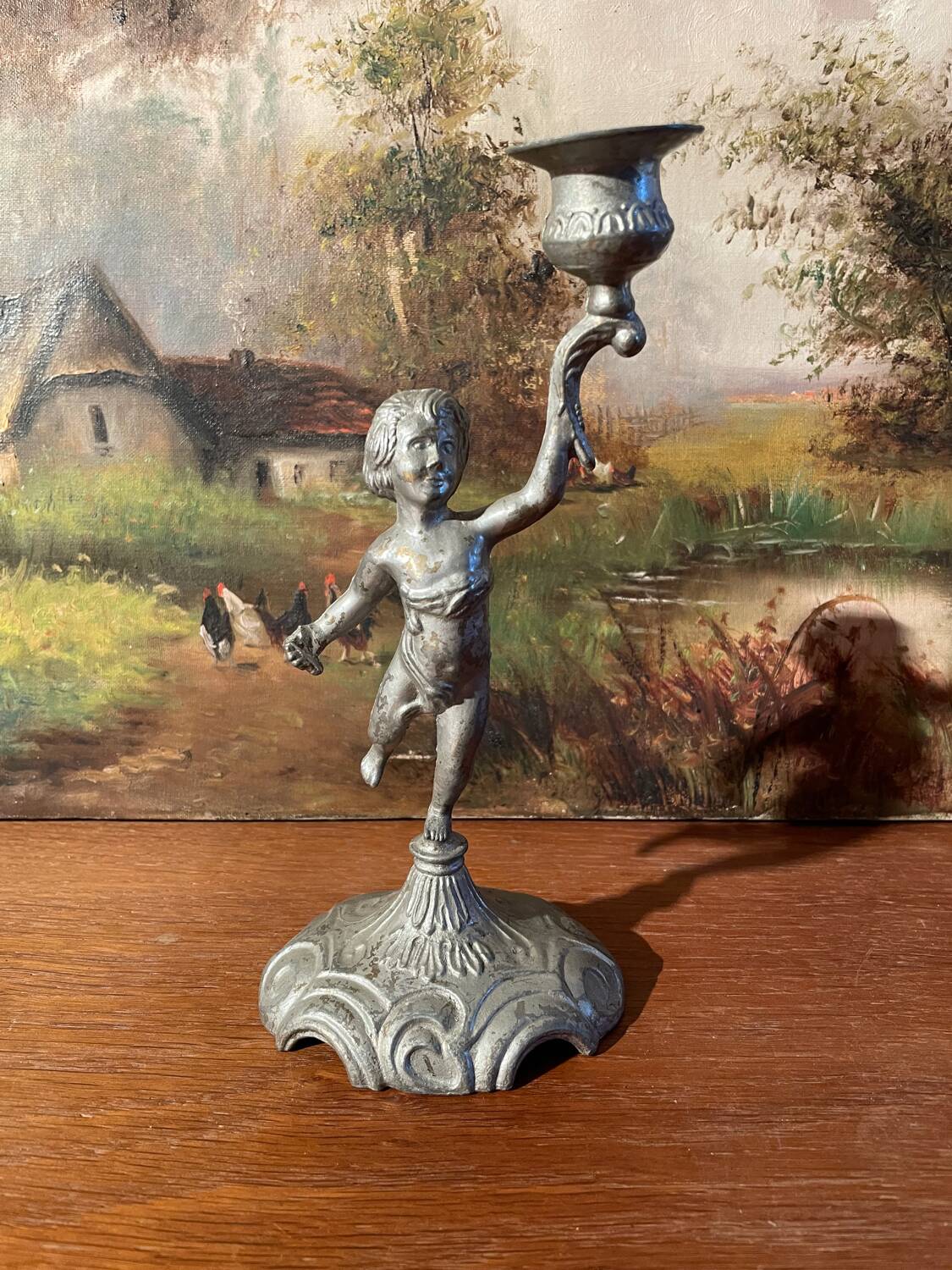 Old cherub candle holder
