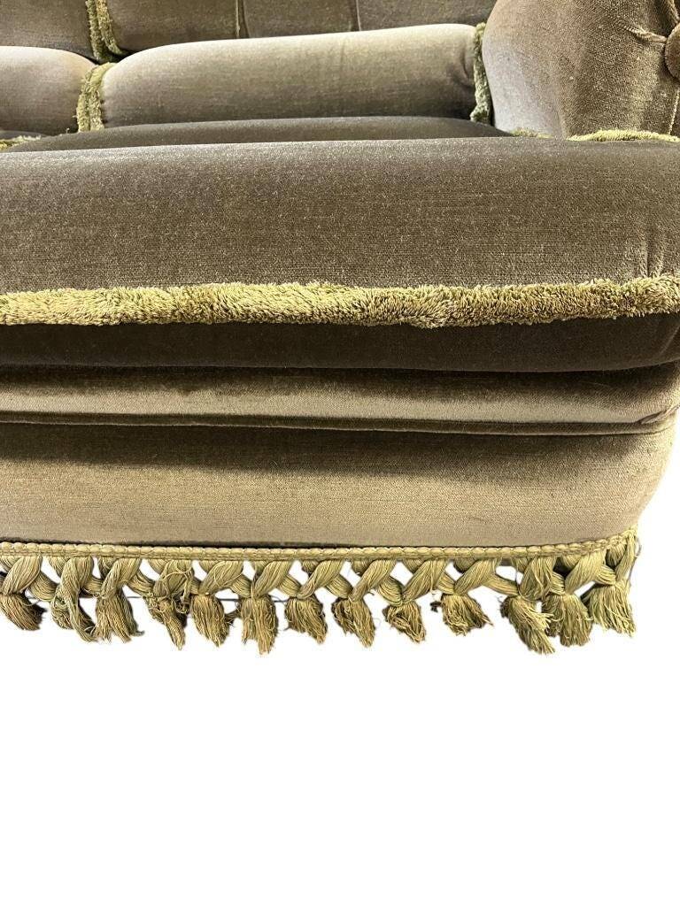 Vintage green two-seater sofa with fringes