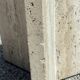 Dining table in travertine, glass top and brass (c.1980)