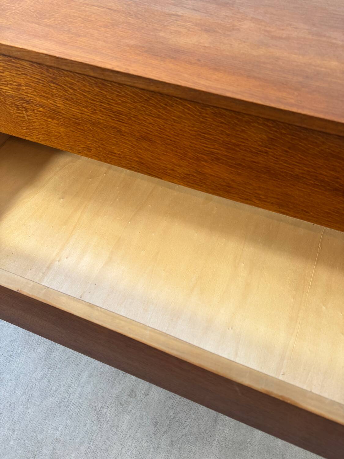 Vintage wooden chest of drawers with tapered legs.