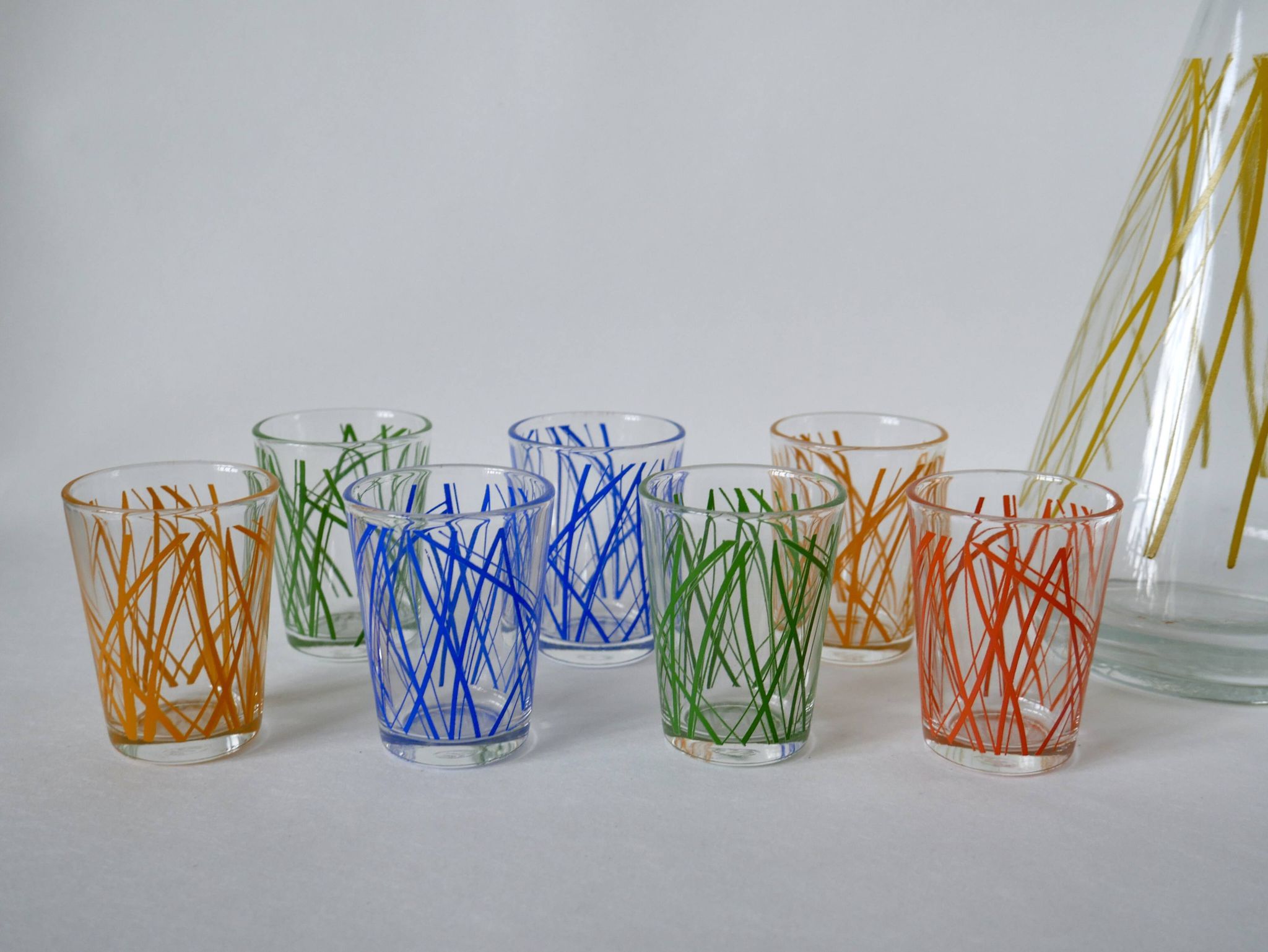 Colorful designer set composed of 7 liqueur glasses and a seventies 70s carafe