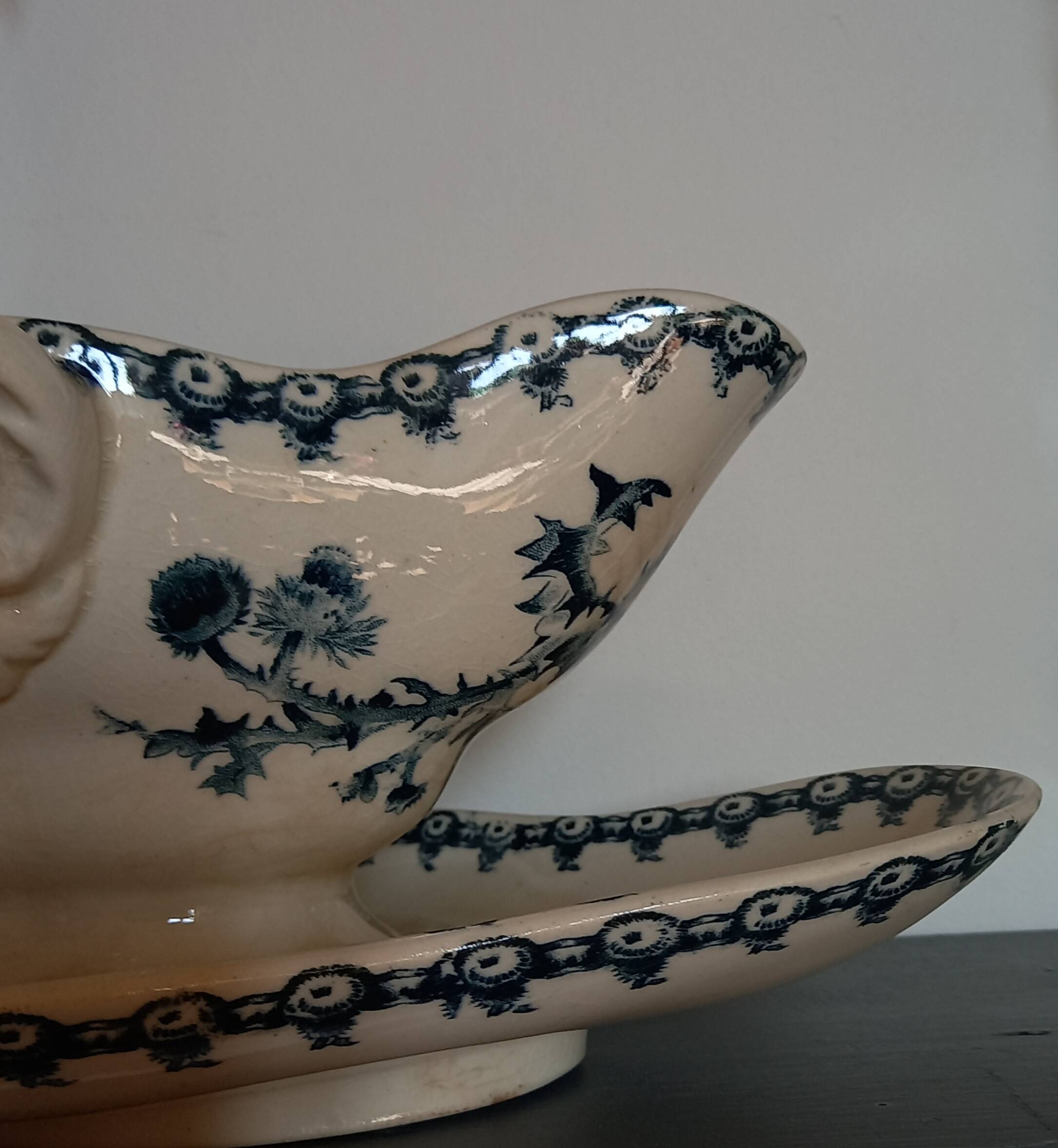 Old gravy boat on frame in terre de fer earthenware by gien, “chardons” model in blue-green