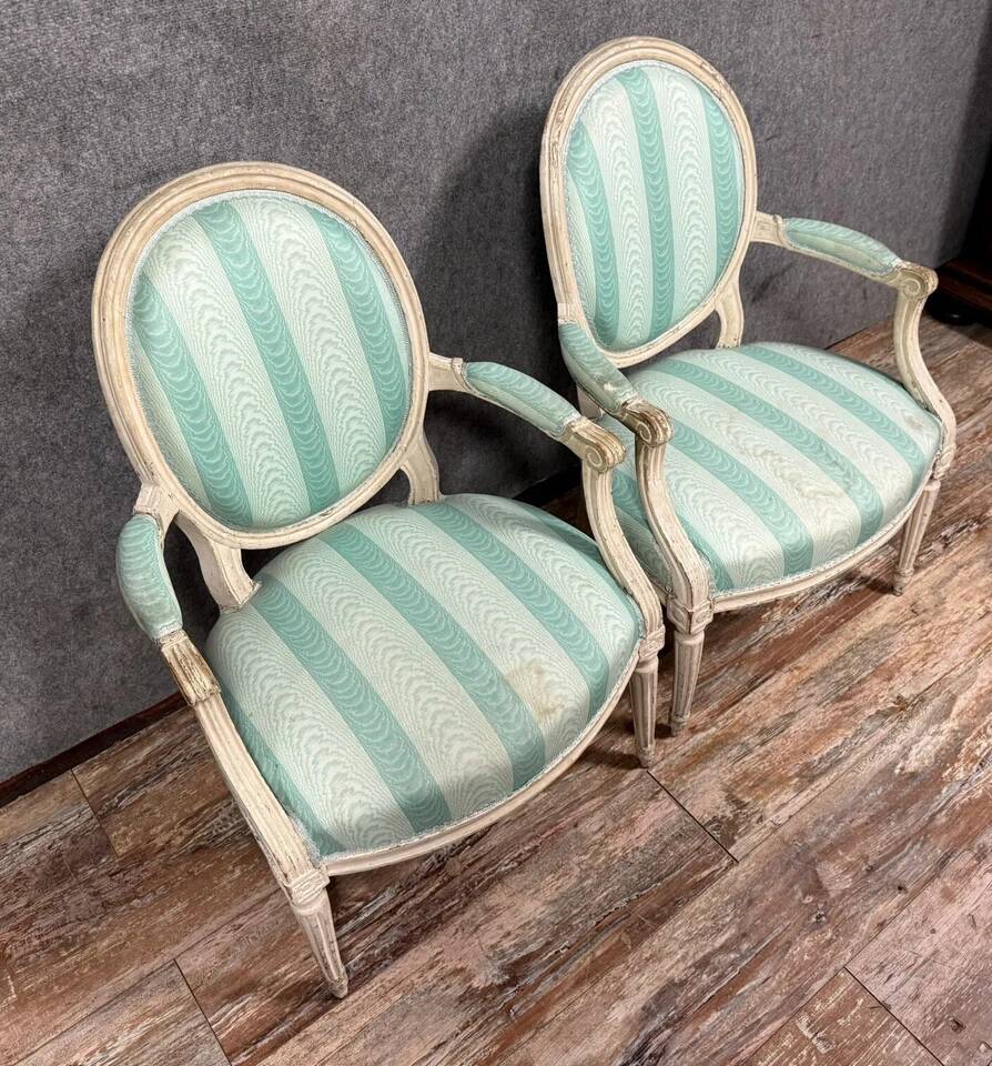 Pair of Louis XVI cabriolet armchairs in lacquered wood, 18th century