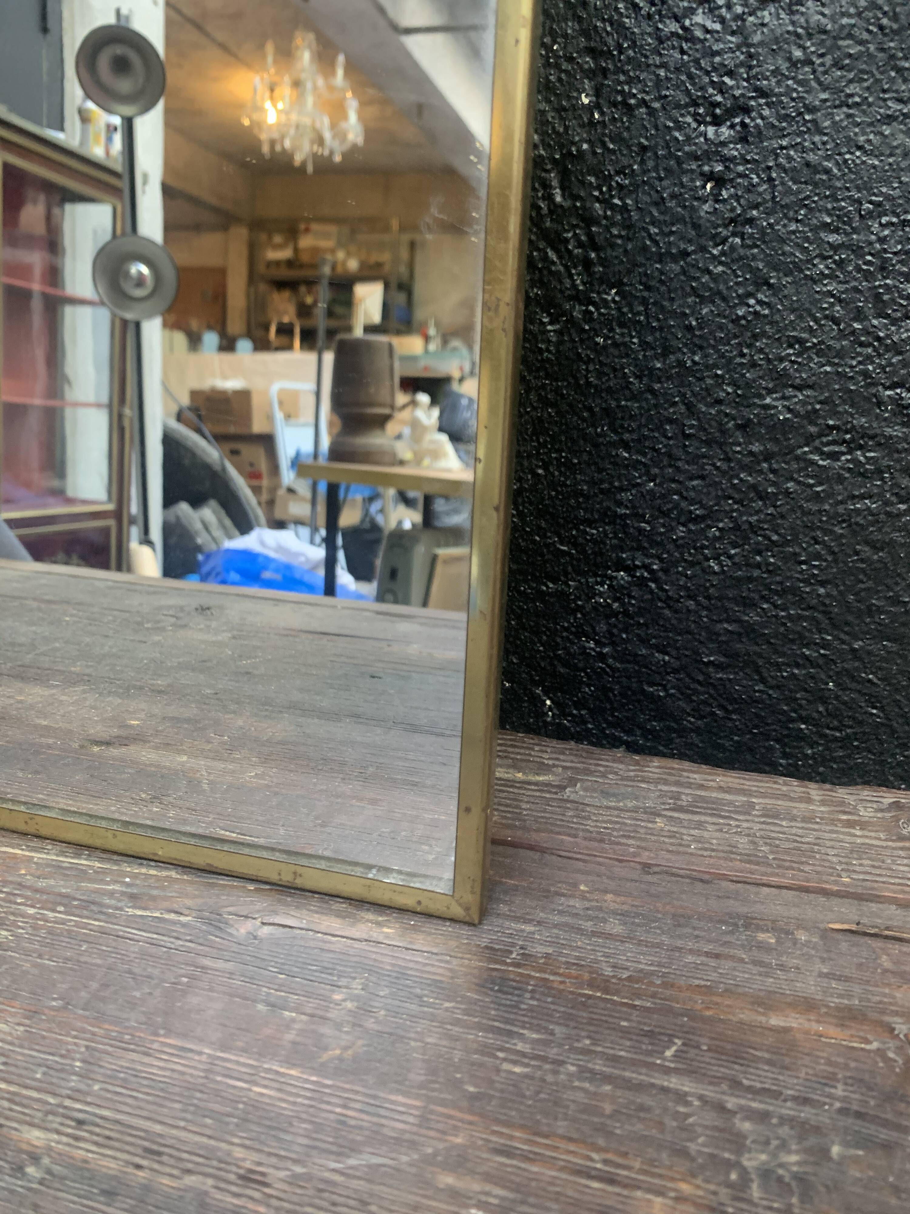 Mirror of two, narrow glass in gold metal 1950