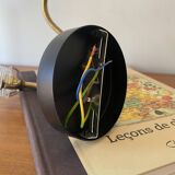 Pair of brass swan neck wall lights with transparent glass shades.