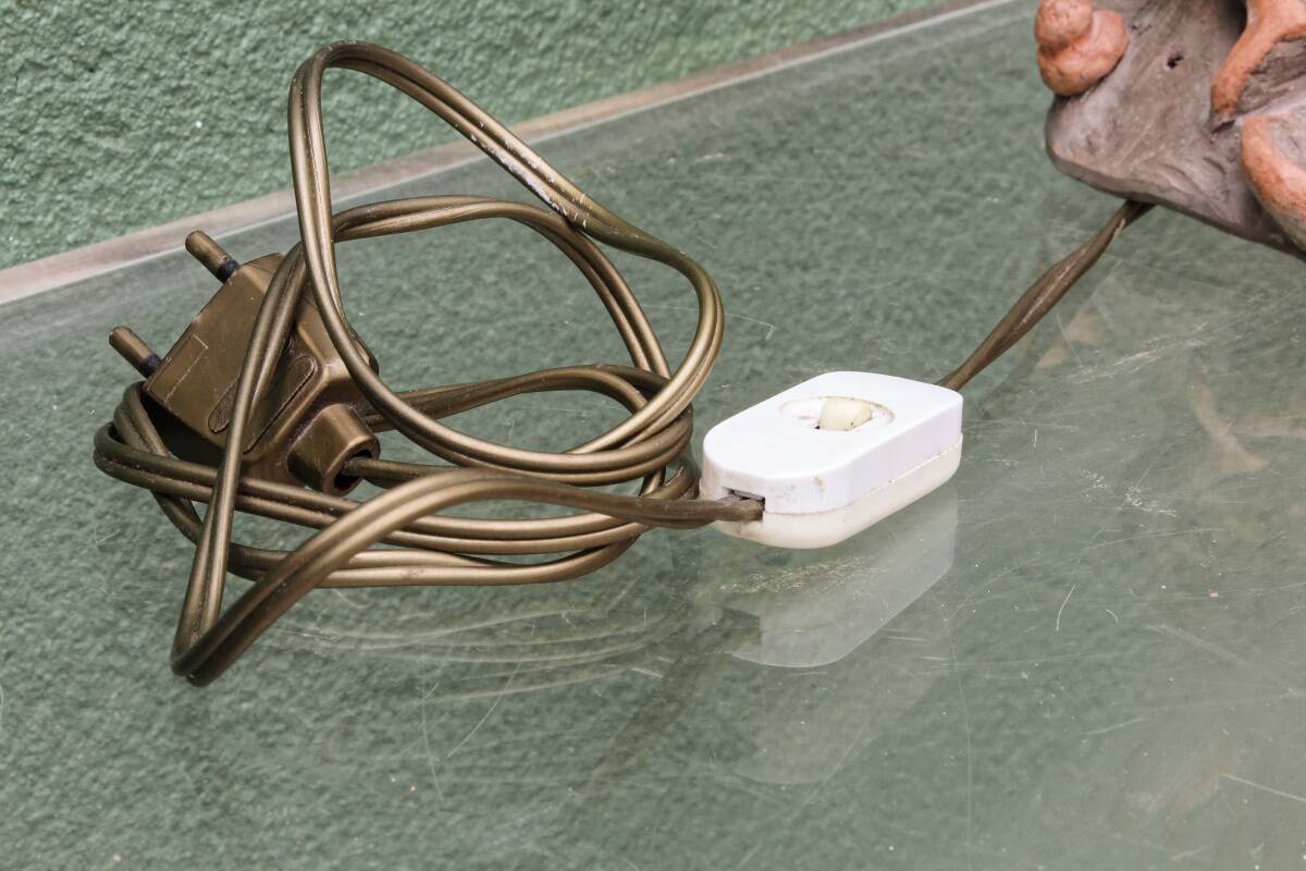 Lamp base in sculpted terracotta featuring birds, signed.