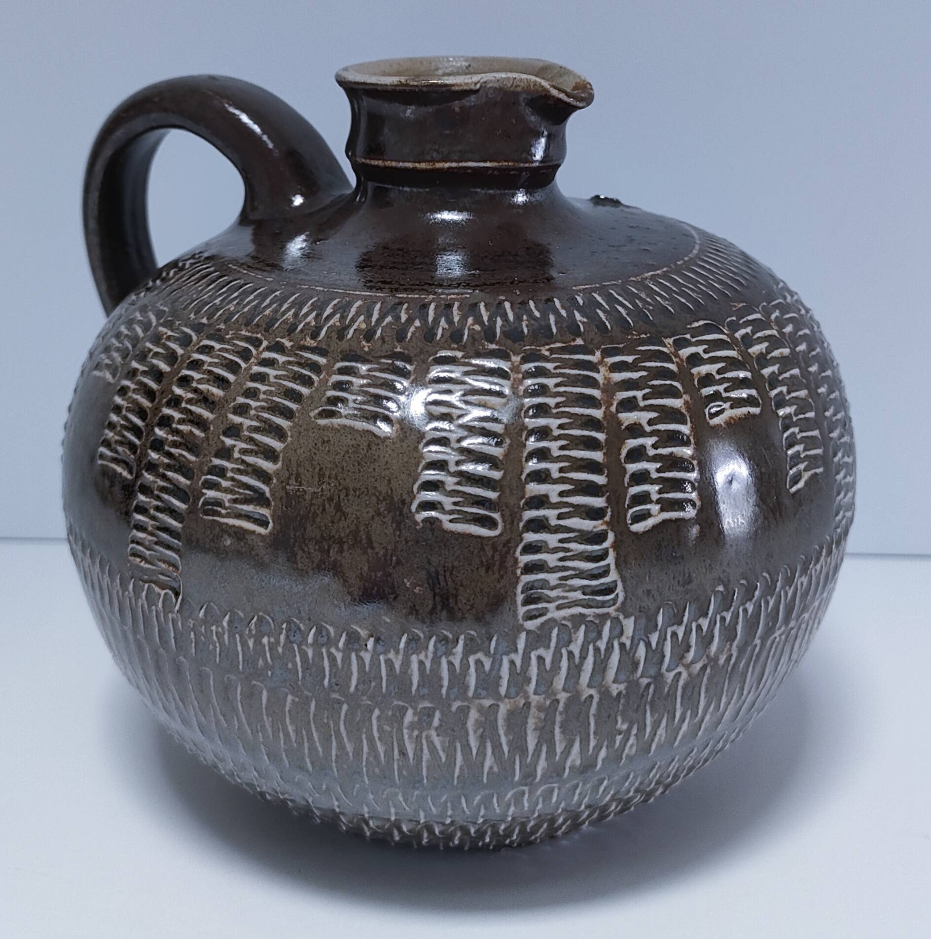 Vintage scarified glazed stoneware pitcher