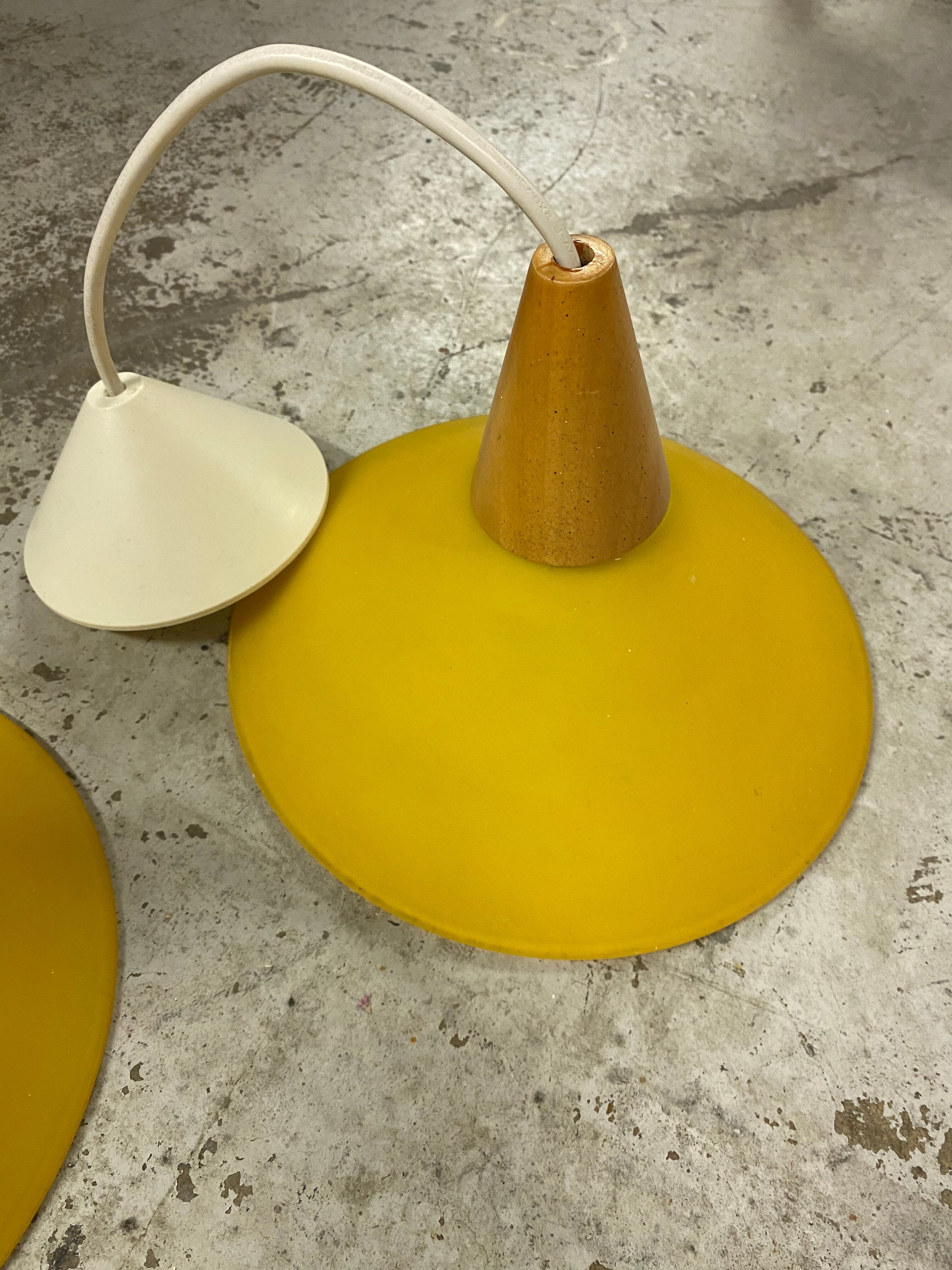 Duo of yellow glass pendant lamps