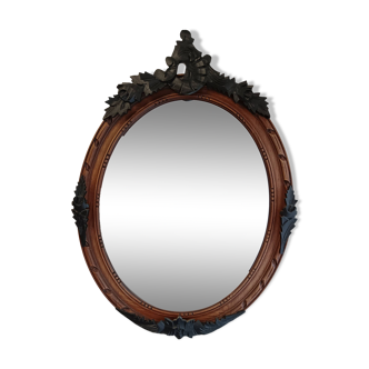 Miroir ancien ovale avec moulures noir et bois