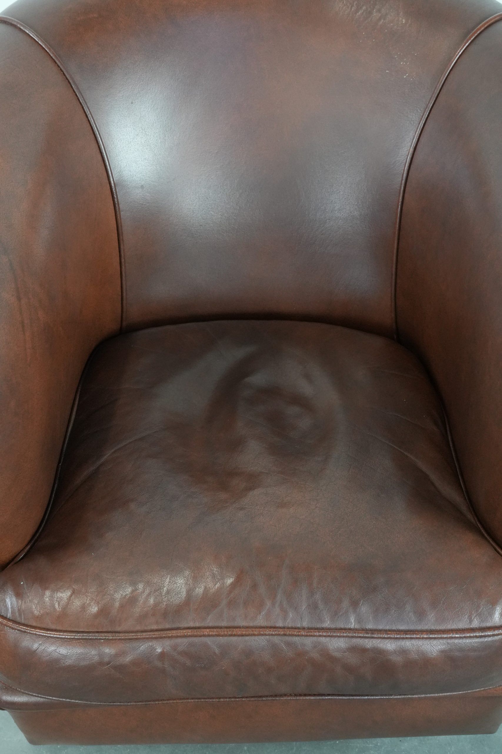 Cognac-coloured cow leather club armchair in English style