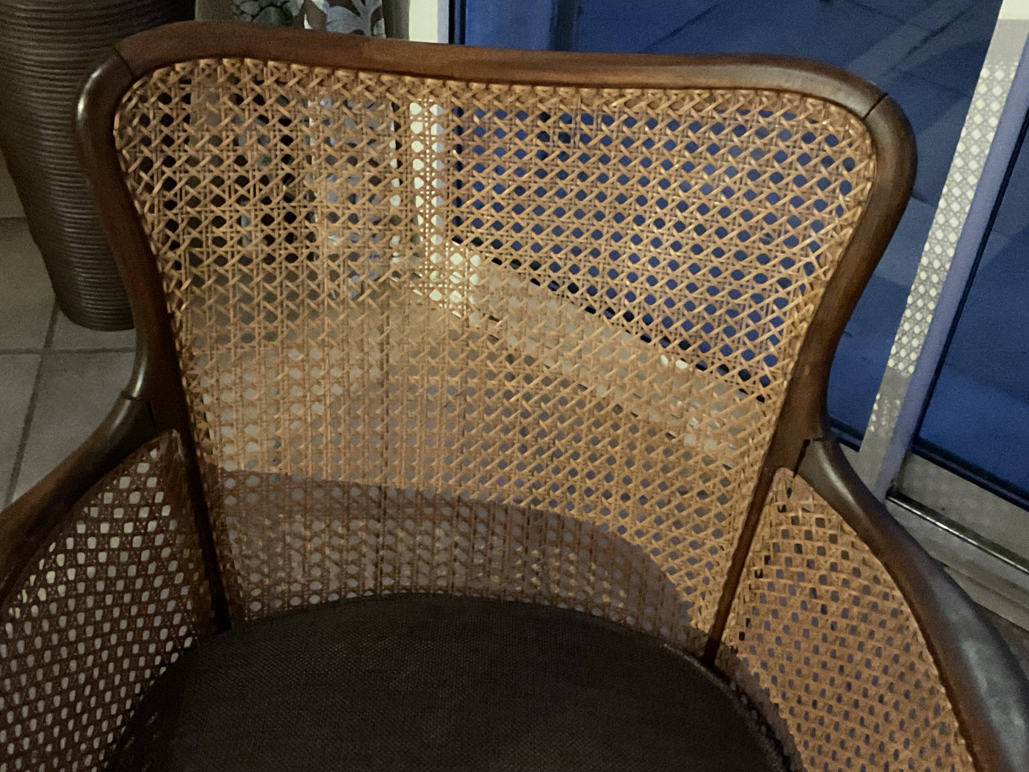 Chair with cane back and recently reupholstered fabric seat.