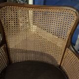 Chair with cane back and recently reupholstered fabric seat.