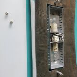 Pair of wall sconces in gold-plated alloy with bas-relief and opaline glass. Germany, 1980