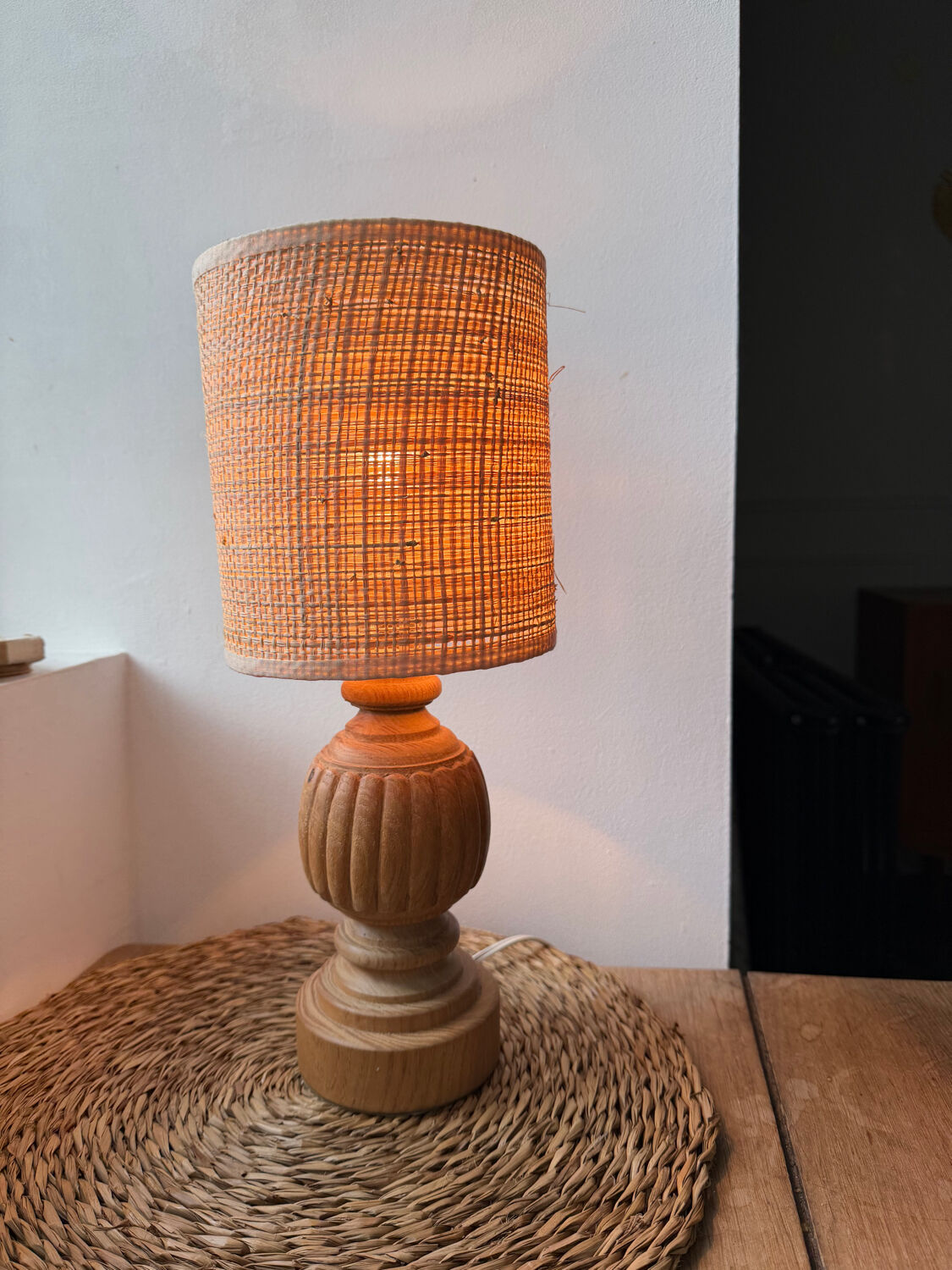 Antique table lamp with a carved wooden base.