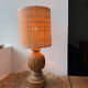 Antique table lamp with a carved wooden base.