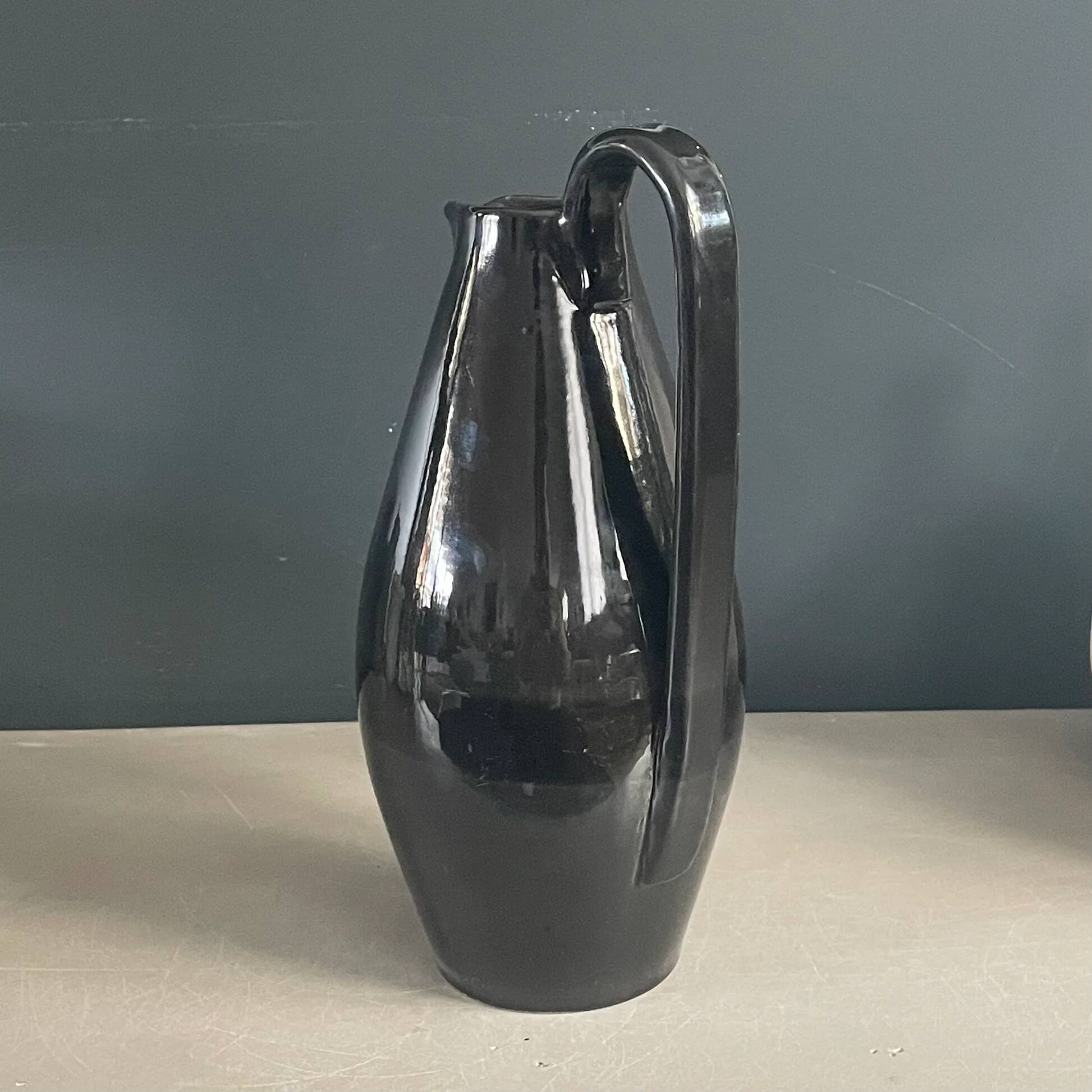 Black glazed ceramic pitcher signed M Azouit