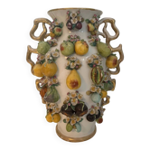 Large antique vase with relief decorations of coloured fruits.