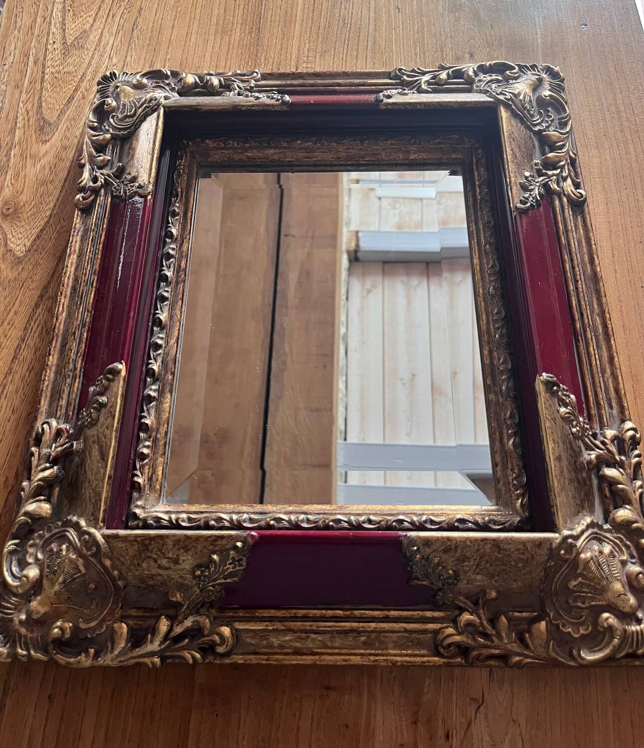 Old mirror with gold and red frame