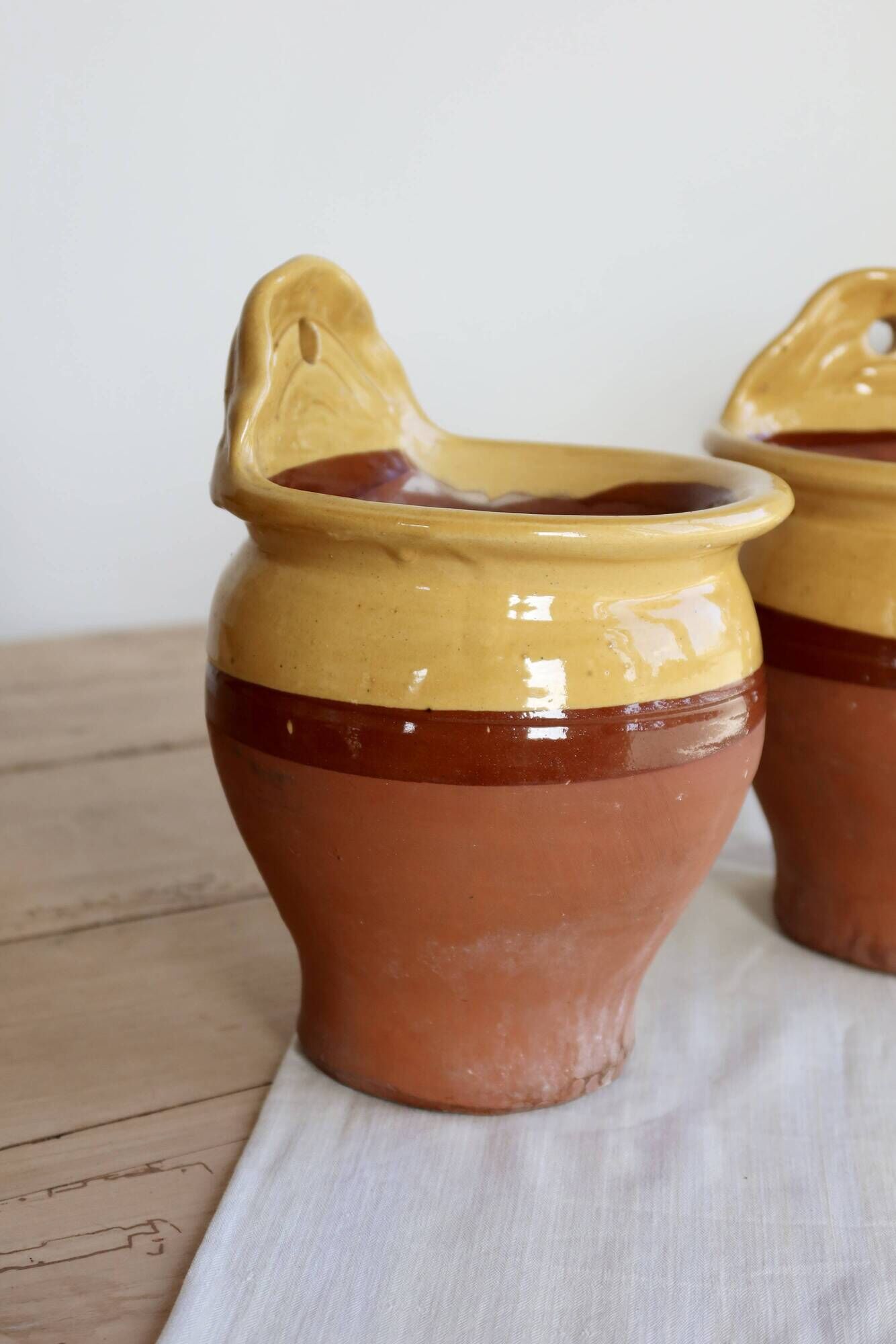 Pair of vintage wall planters in yellow glazed stoneware.