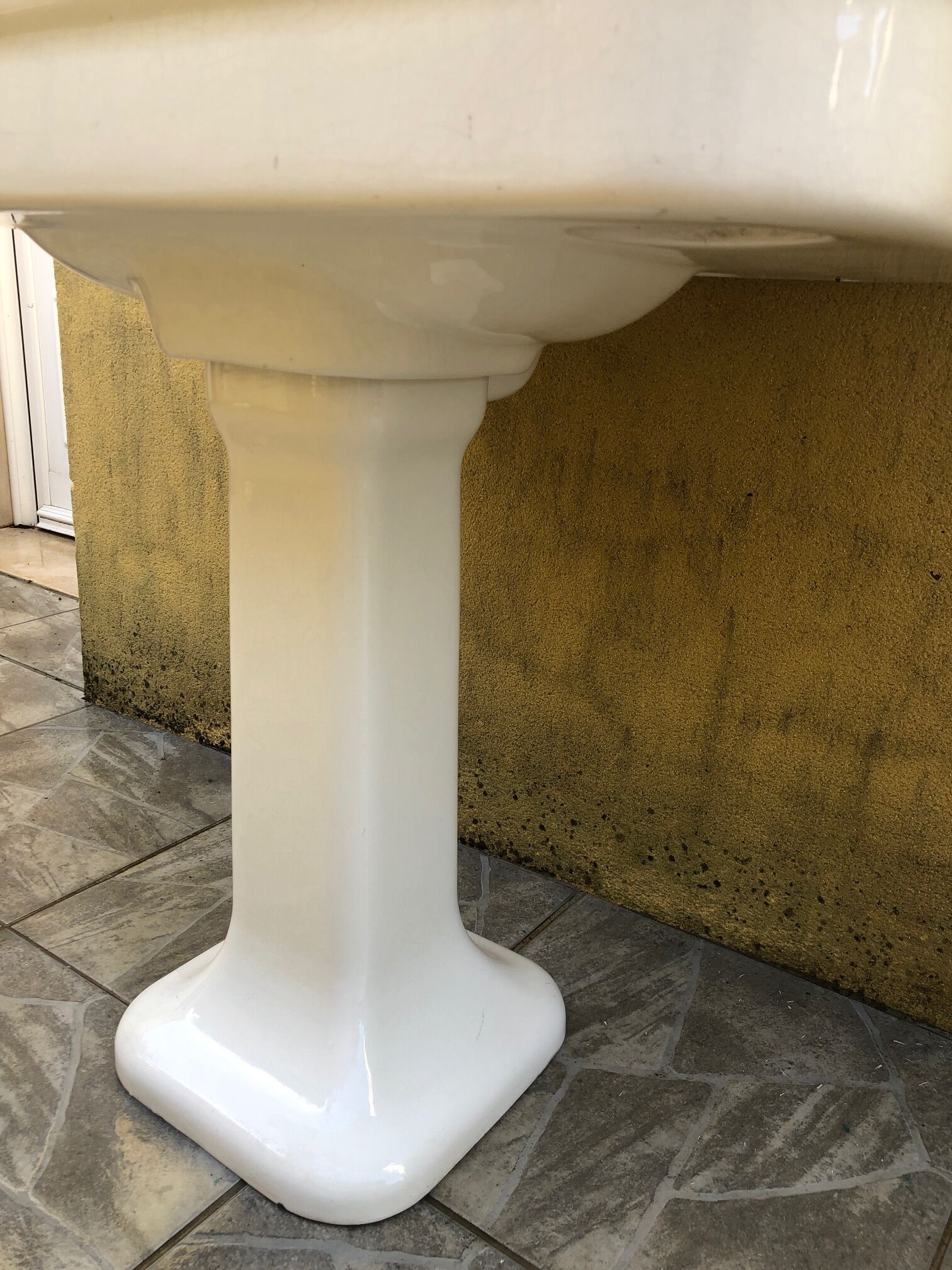 Antique washbasin on ceramic column