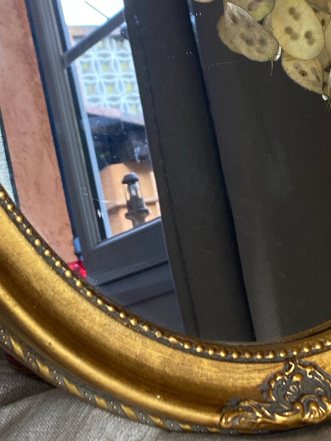 Oval-shaped gilded wooden mirror