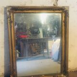 Old mirror with gilded leaves and flowers carved on top of it 1800s