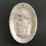 Character on plaster medallion