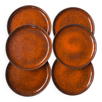 Ceramic plates with orange glaze from the 1970s.