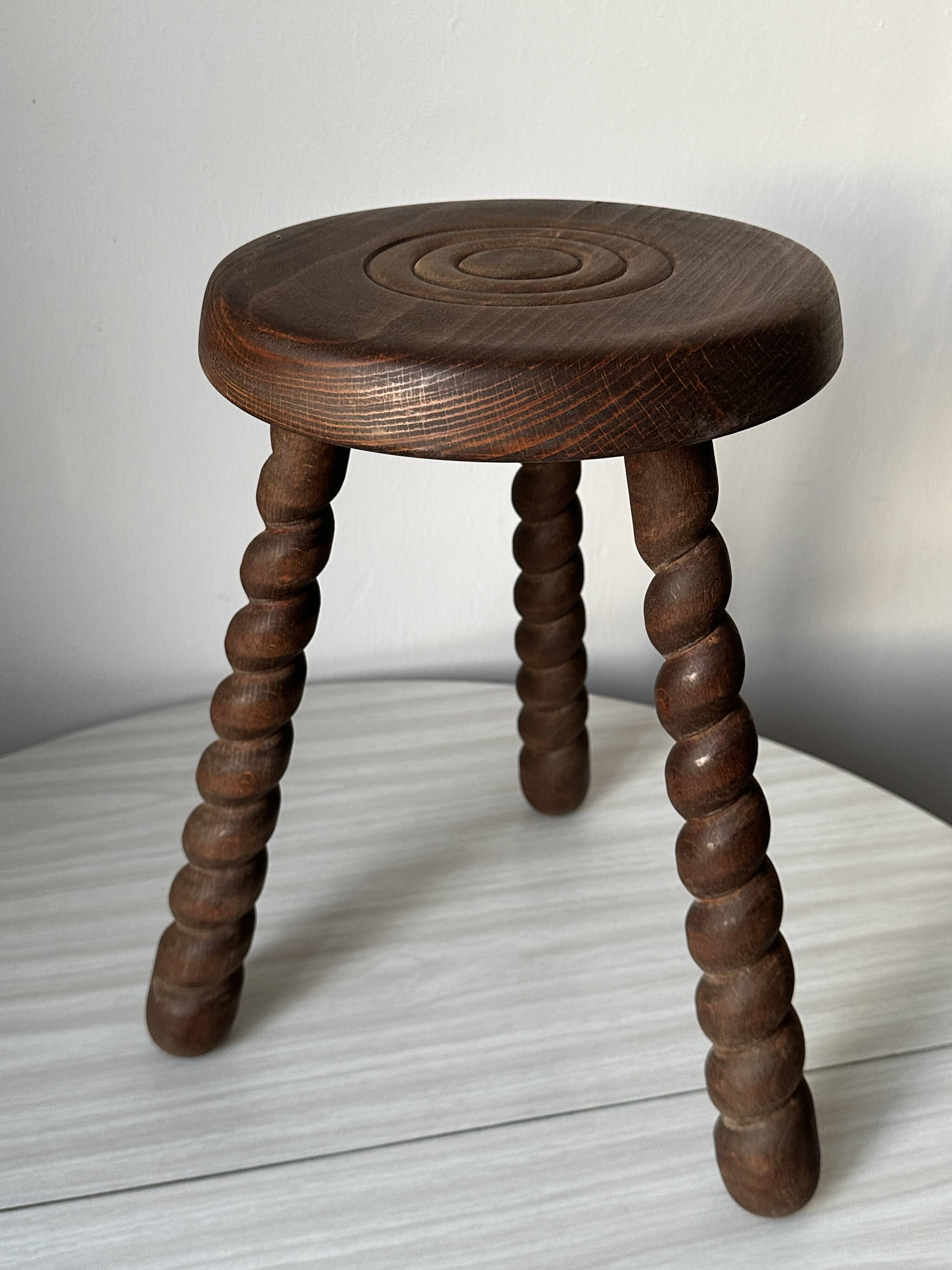 Wooden stool with three twisted legs